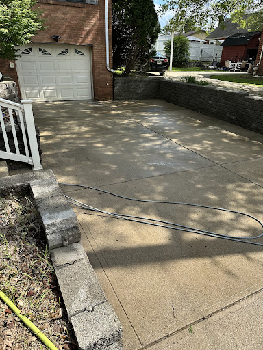 A large freshly pressure washed concrete driveway in Pittsburgh